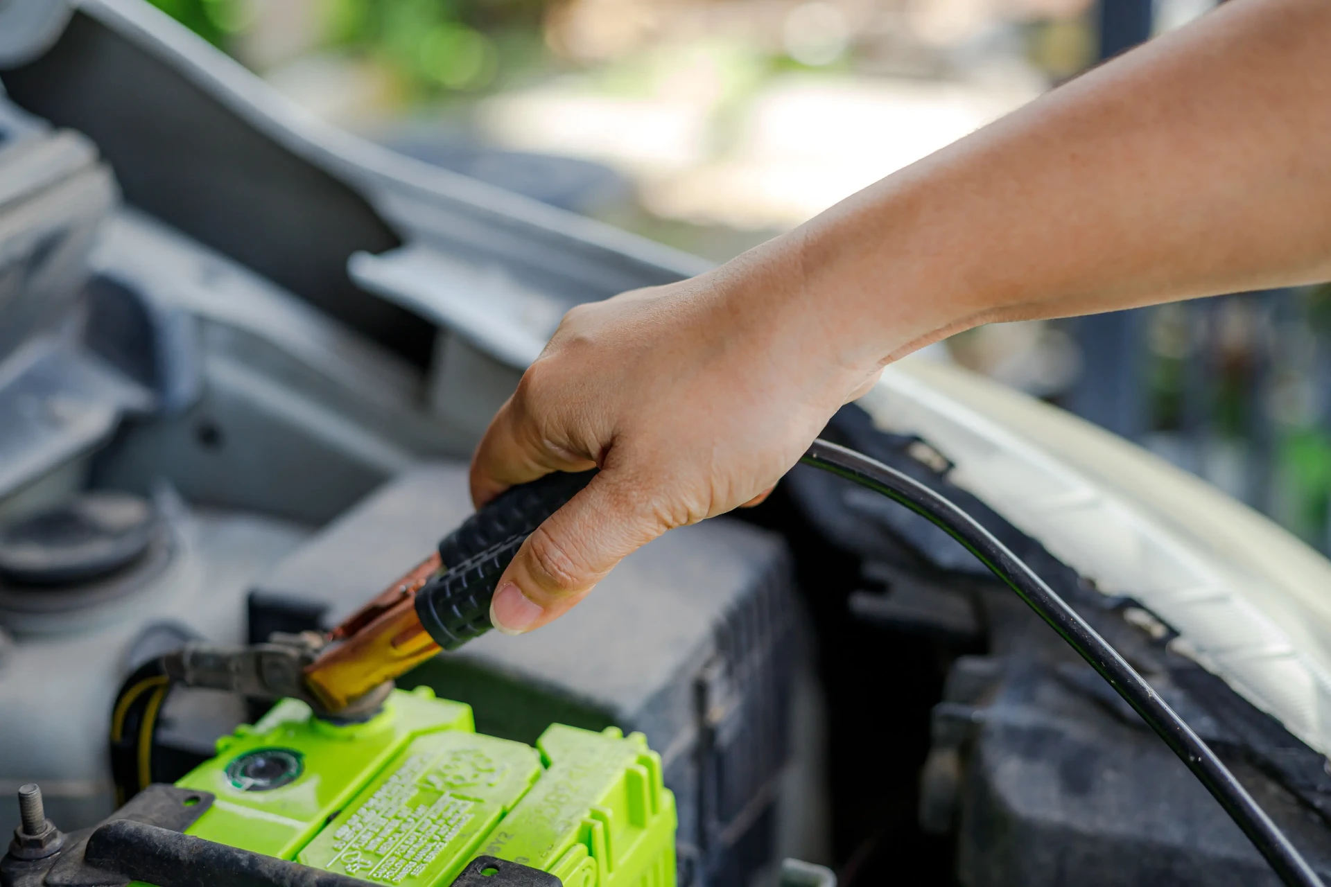 Close-up of a car battery in an engine bay