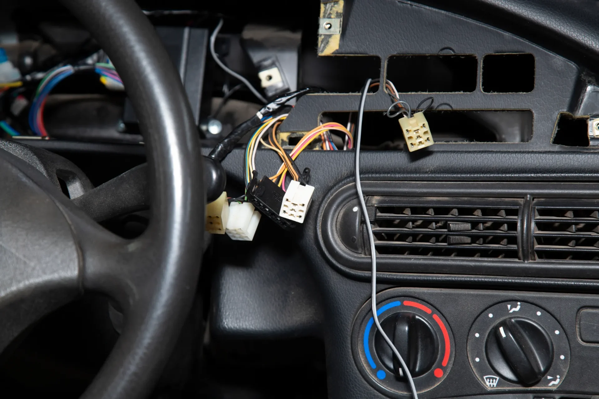 Auto electrician inspecting a vehicle's wiring